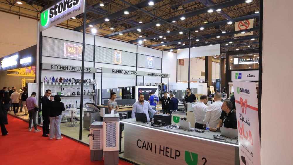 Visitors at an appliance stand on the HOMEX floor.