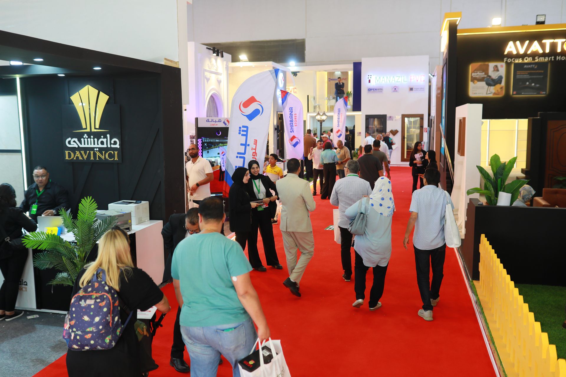 Visitors on the HOMEX exhibition floor — a crowded, booth-lined aisle at the 6th edition.